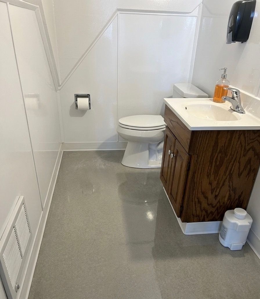 Same commercial restroom sparkling clean after Rebekah’s Cleaning Service