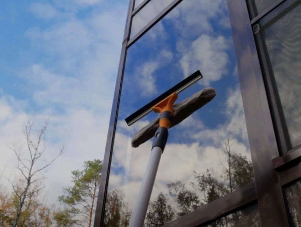 Professional window and screen cleaning on commercial glass